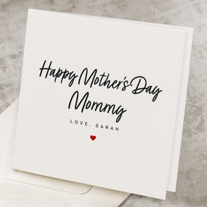 May include: White card with black text that reads "Happy Mother's Day Mommy" and "LOVE, SARAH" with a small red heart below the text.