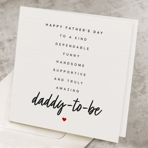 May include: A white card with black text that reads "Happy Father's Day to a kind, dependable, funny, handsome, supportive and truly amazing daddy-to-be". A small red heart is below the text.