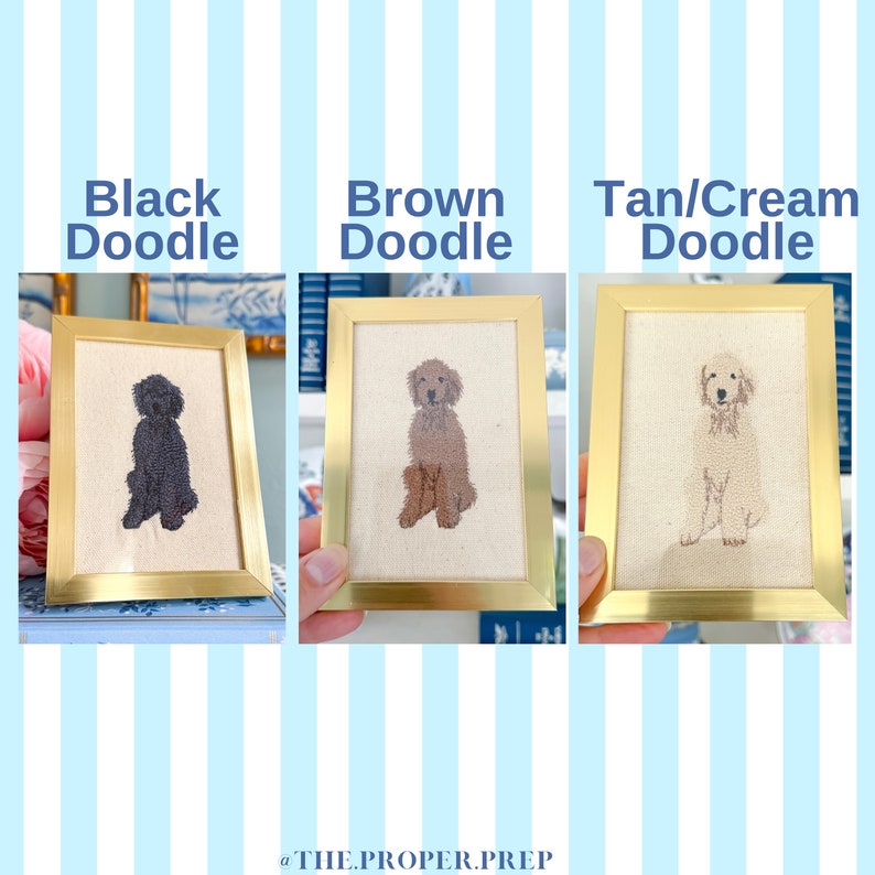 May include: Three framed embroidered pictures of doodle dogs in black, brown, and tan/cream colours. The frames are gold and the background is a blue and white striped pattern.