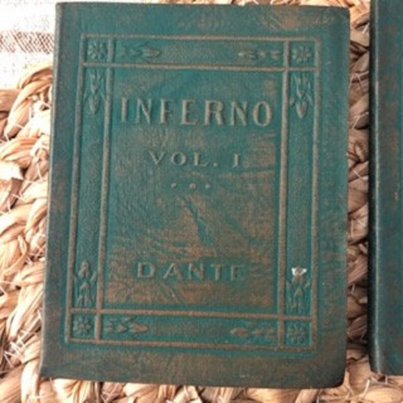 May include: A green leather-bound book with the title "Inferno Vol. I" and the author "Dante" embossed in gold lettering.