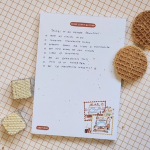 May include: A handwritten checklist on a white sheet of paper with the title "Things to do before Dawntrail:"  The list includes items such as "level all classes", "complete Manderville quests", and "get all Splendorous Tools".