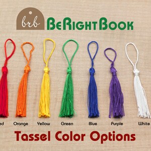 May include: A row of ten tassels in different colors, including pink, red, orange, yellow, green, blue, purple, white, and black. The tassels are arranged in a line on a wooden surface. The text "brb BeRightBook" and "Tassel Color Options" is visible below the tassels.