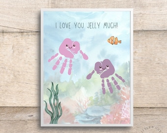May include: A framed print with an underwater scene. Two handprint jellyfish with smiling faces float in the water, with the text "I LOVE YOU JELLY MUCH!" above them. An orange clownfish swims nearby, with coral and seaweed in the background.