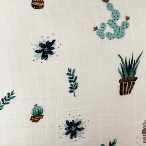 May include: White fabric with a repeating pattern of green and brown potted plants, including cacti and succulents.