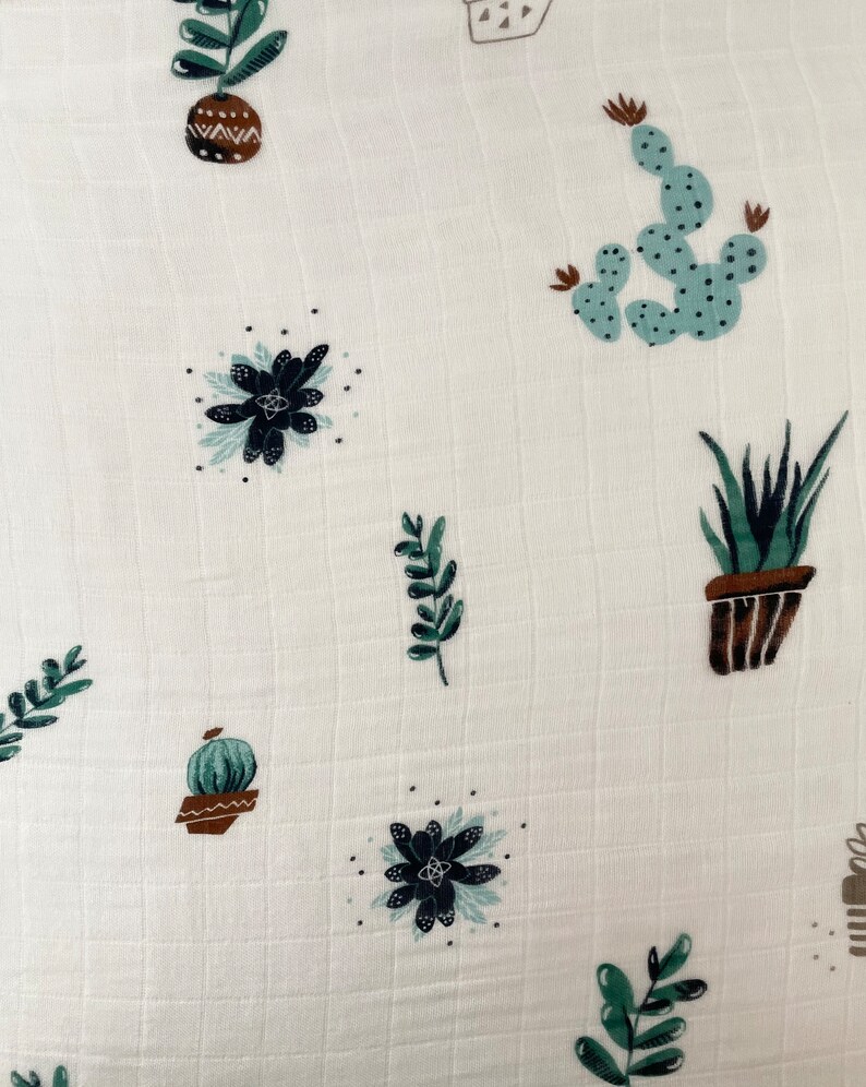 May include: White fabric with a repeating pattern of green and brown potted plants, including cacti and succulents.