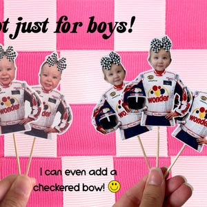 May include: Cupcake toppers with a baby's face in a racing suit and a checkered bow. The toppers are on wooden sticks, with the text "not just for boys!" and "I can even add a checkered bow!" on a pink and white checkered background.