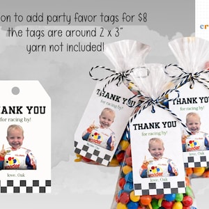 May include: Party favour bags with tags saying "THANK YOU for racing by!" and a photo of a child in a racing suit. The tags have a black and white chequered pattern. The bags are filled with colourful sweets.