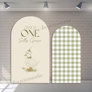 May include: Two arched backdrop panels. One features a watercolour illustration of a goose wearing a hat, with the text "GRAY IS ONE Silly Goose." The other panel has a green and white gingham pattern.