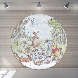 May include: A circular decorative plate depicting a picnic scene with Winnie the Pooh and friends. The illustration includes Tigger, Piglet, Eeyore, Roo, and Rabbit. The plate has a light blue sky and green grass background.