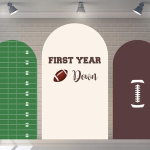 May include: Three arched wall decals with a football theme. The left decal is green and white with yard lines and numbers. The middle decal is beige with a brown football and the text "FIRST YEAR Down". The right decal is brown with a white outline of a football.