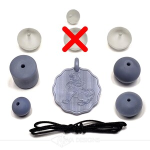 May include: A light purple pendant featuring a lion design, accompanied by several light purple beads of varying shapes, three small translucent suction cups, and a black cord. The pendant has a scalloped edge and a top loop for hanging.