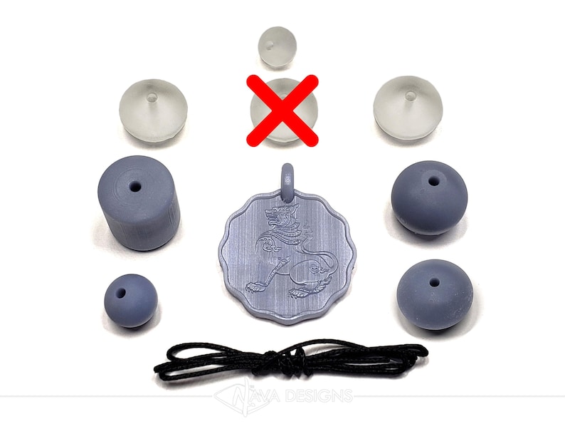 May include: A light purple pendant featuring a lion design, accompanied by several light purple beads of varying shapes, three small translucent suction cups, and a black cord. The pendant has a scalloped edge and a top loop for hanging.
