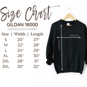May include: A black Gildan 18000 unisex sweatshirt hanging on a wooden hanger, accompanied by a size chart. The chart lists sizes S through 3XL with corresponding width and length measurements in inches, ranging from 20 to 30 inches wide and 27 to 32 inches long.