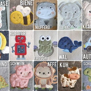 K&ouml;nnte beinhalten: Eine Sammlung von gestickten Filzaufn&auml;hern mit verschiedenen Tieren und Objekten. Designs umfassen ein Kaninchen, eine Biene, ein Nilpferd, einen Elefanten, einen Koala, einen Hei&szlig;luftballon, einen Roboter, einen Frosch, einen Wal, ein Auto, einen Dinosaurier, ein Schwein, einen Affen, eine Kuh und eine Schildkr&ouml;te.