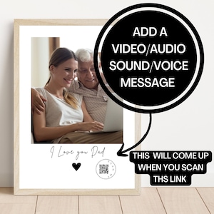 May include: A framed photograph of a father and daughter looking at a laptop together. The photo has a black and white heart and the text "I Love you Dad" below the image. A QR code is in the bottom right corner with the text "Scan Me" next to it. The text "ADD A VIDEO/AUDIO SOUND/VOICE MESSAGE" is in a black circle above the photo. The text "THIS WILL COME UP WHEN YOU SCAN THIS LINK" is below the photo.