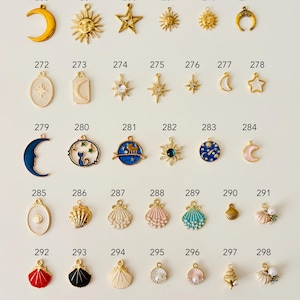May include: A collection of small, decorative charms in various celestial and nautical designs. The charms include moons, suns, stars, seashells, and other shapes, in gold, silver, and colorful enamel finishes. These charms are ideal for jewelry making.
