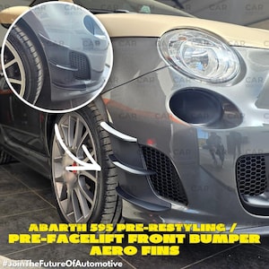 May include: A close-up of a grey and beige Abarth 595 car, highlighting the front bumper. The bumper has black aero fins with white detailing. Text reads "ABARTH 595 PRE-RESTYLING / PRE-FACELIFT FRONT BUMPER AERO FINS".