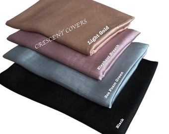 May include: A stack of five fabric squares in various colors: light gold, elephant breath, sea foam green, and black. The text "CRESCENT COVERS" is printed on the top square. Each square has a different color name printed on it.