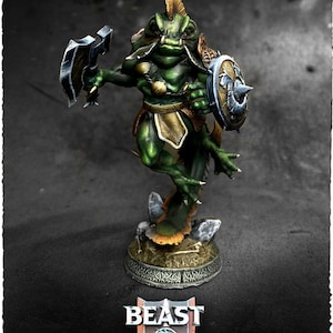 May include: A green Mugget miniature figure from the world of Ellie Storm and the Blood Shard. The figure is posed with a shield and weapon. The figure has a gold and brown color scheme. The base has the words "Beast Miniatures".