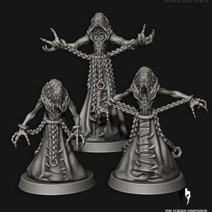 May include: Three gray, detailed, miniature figures of humanoid creatures with long, clawed fingers and chains wrapped around their bodies. The figures are standing on circular bases.