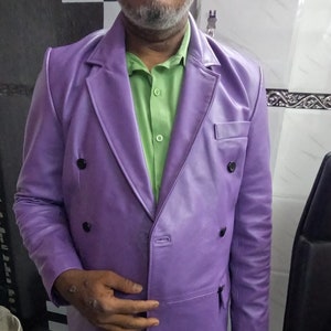 May include: A purple leather double-breasted blazer with a green button-down shirt underneath.