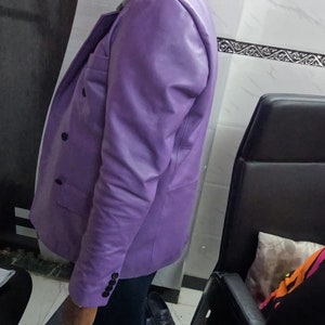 May include: A purple leather blazer with a double-breasted closure and a single button cuff.