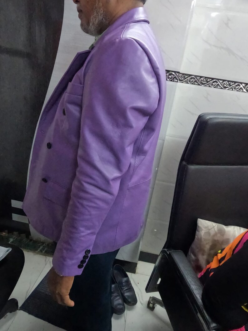 May include: A purple leather blazer with a double-breasted closure and a single button cuff.