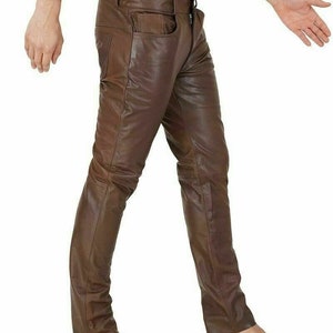 May include: Brown leather pants with a slim fit. The pants have a five-pocket design and a zipper fly.