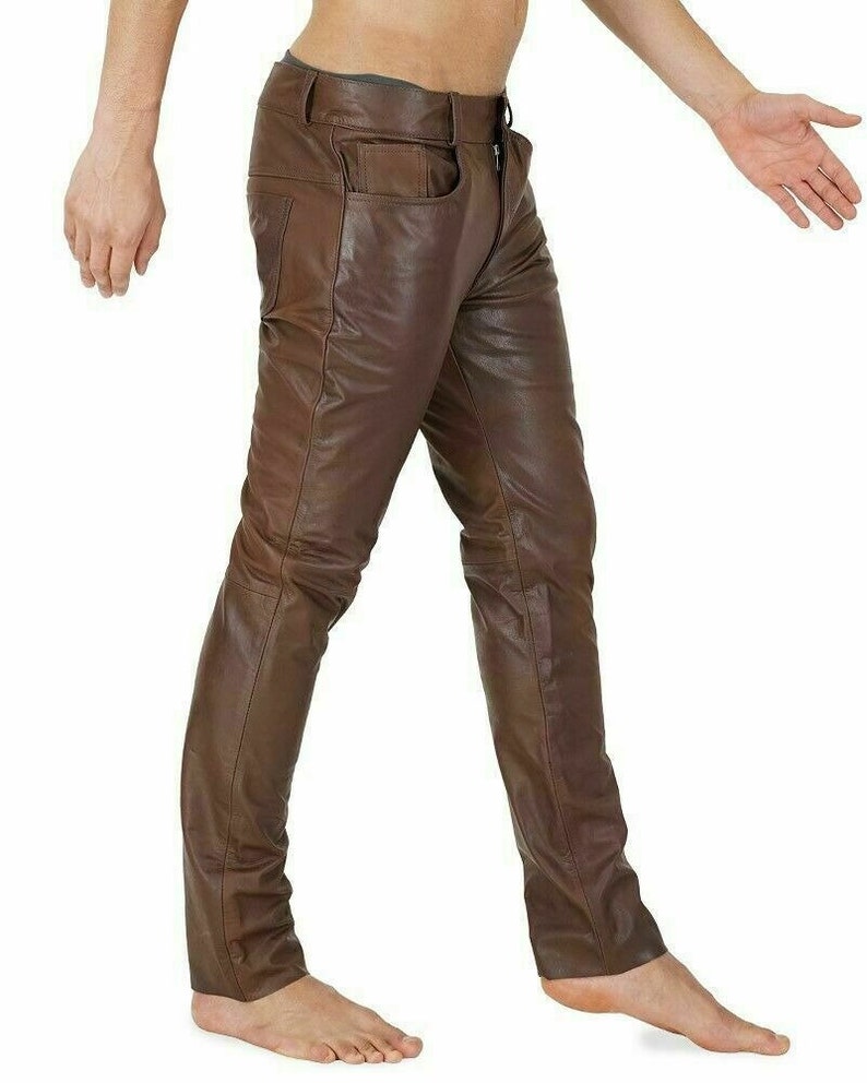 May include: Brown leather pants with a slim fit. The pants have a five-pocket design and a zipper fly.