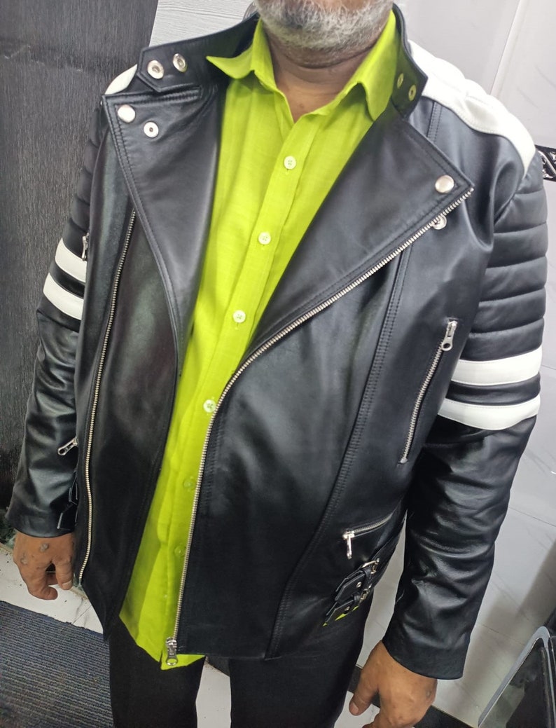 May include: A black leather jacket with white stripes on the sleeves and shoulders. The jacket has a zipper closure and multiple pockets.