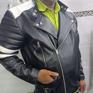 May include: A black leather motorcycle jacket with white accents on the shoulders and sleeves. The jacket has a zipper closure and multiple pockets.