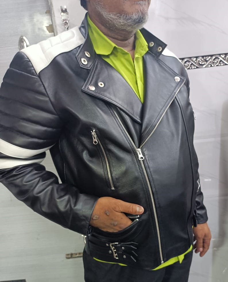 May include: A black leather motorcycle jacket with white accents on the shoulders and sleeves. The jacket has a zipper closure and multiple pockets.