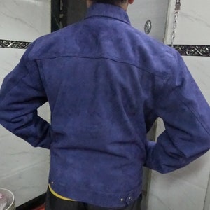 May include: A blue suede jacket with a button-up front and long sleeves.