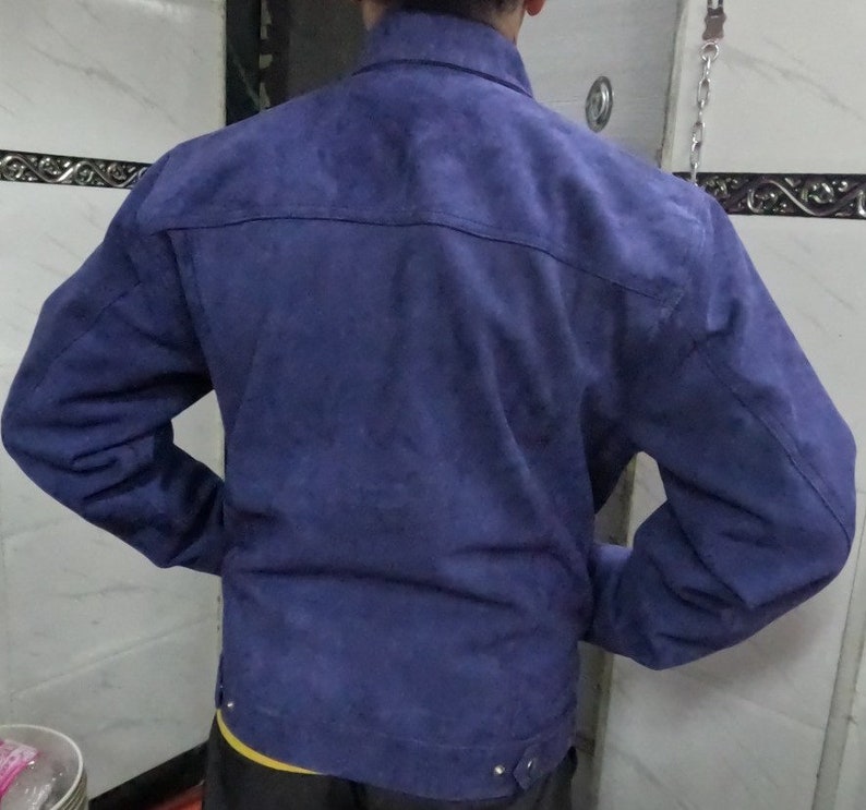 May include: A blue suede jacket with a button-up front and long sleeves.
