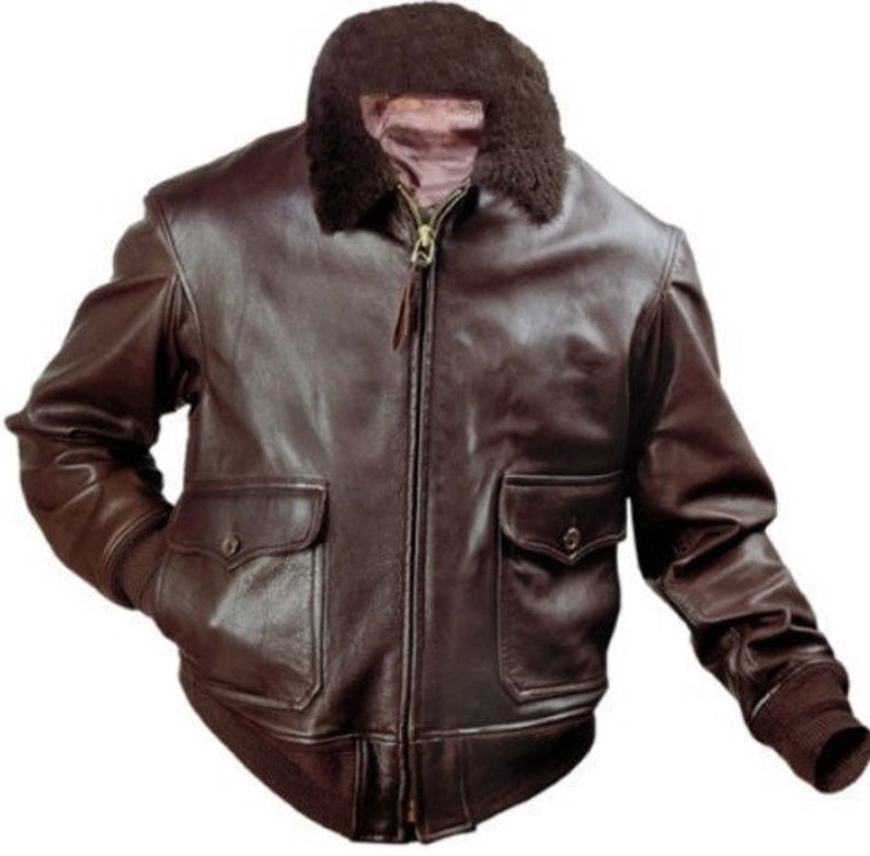 May include: A brown leather bomber jacket with a shearling collar and zipper closure. The jacket has two flap pockets and ribbed cuffs.