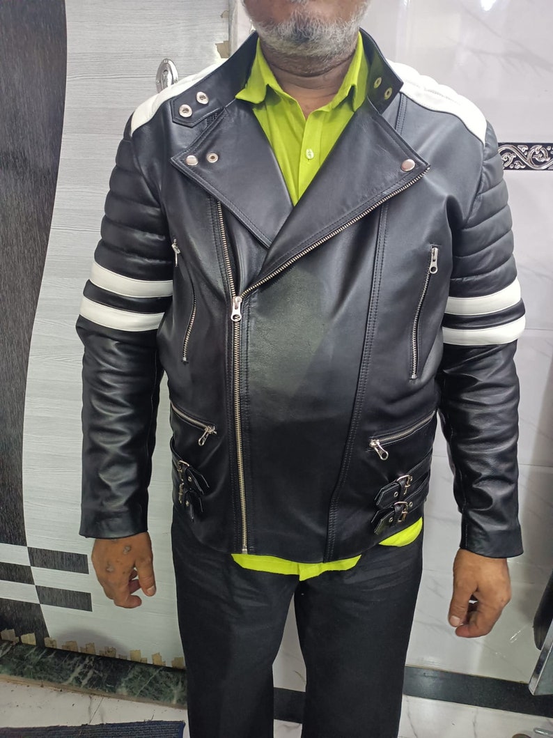 May include: A black leather motorcycle jacket with white stripes on the sleeves and collar. The jacket has a zipper closure and multiple pockets.