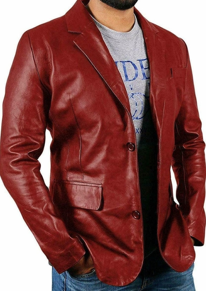 May include: A burgundy leather blazer with a three-button closure and a single pocket on the left side.