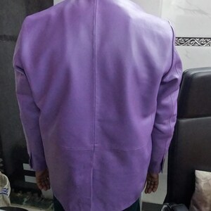 May include: A purple leather jacket with a button-up front and long sleeves.