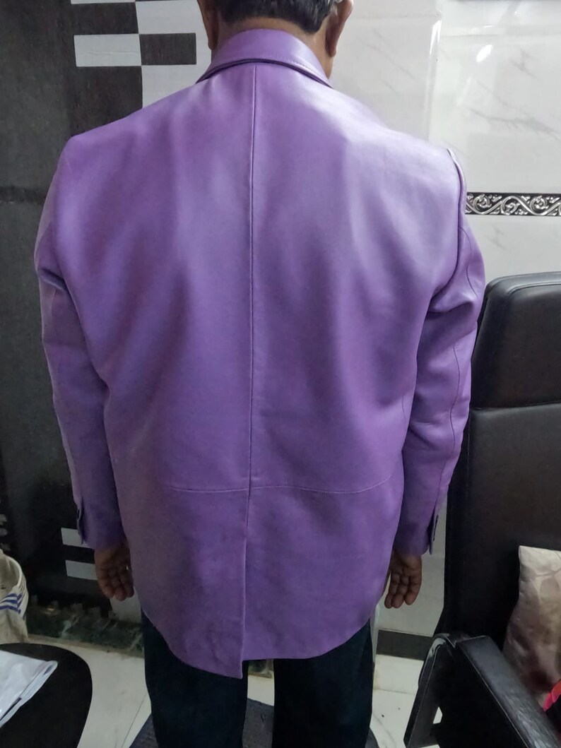 May include: A purple leather jacket with a button-up front and long sleeves.