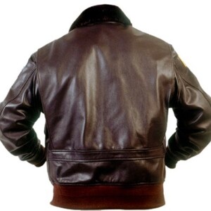 May include: A brown leather bomber jacket with a fur collar and a ribbed knit bottom band.