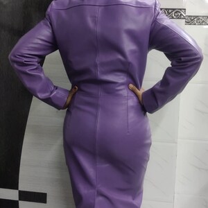 May include: A purple leather dress with a long sleeve and a fitted silhouette.