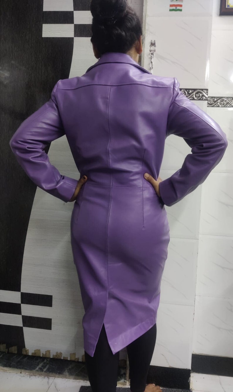 May include: A purple leather dress with a long sleeve and a fitted silhouette.