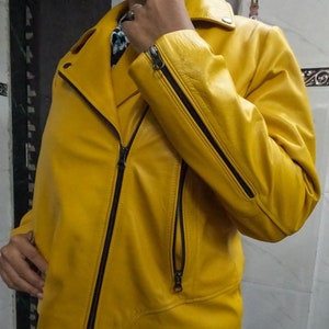 May include: A bright yellow leather jacket with a zipper closure and black accents. The jacket has a collar and two pockets.