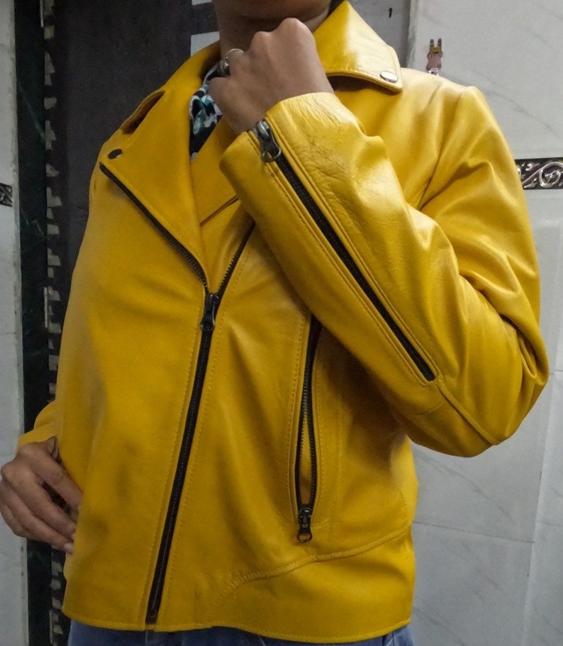 May include: A bright yellow leather jacket with a zipper closure and black accents. The jacket has a collar and two pockets.