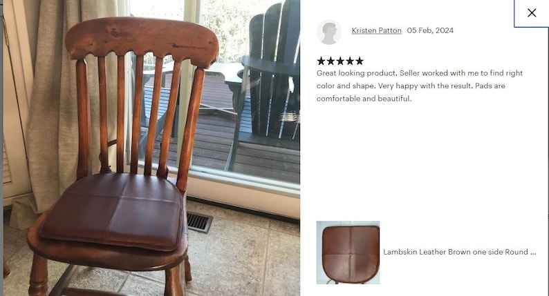 May include: A brown leather chair pad with a quilted design. The pad is placed on a wooden chair with a slatted back.