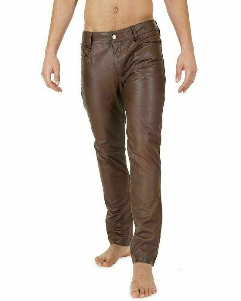 May include: Brown leather pants with a slim fit. The pants have a five-pocket design and a zipper fly.
