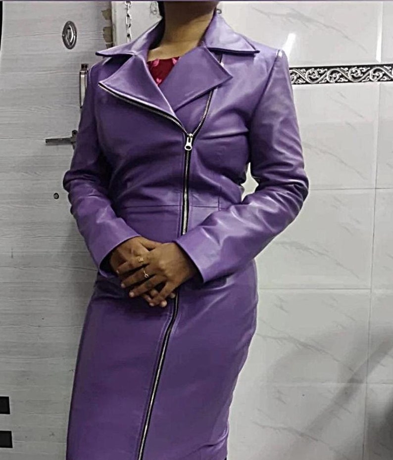 May include: A long-sleeved purple leather dress with a zip fastening. The dress has a fitted bodice and a straight skirt.