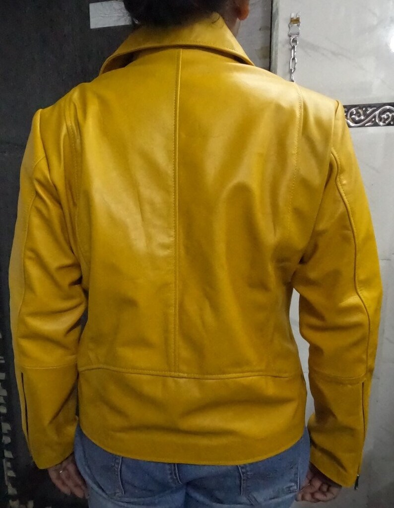 May include: A yellow leather jacket with a zipper closure. The jacket has a stand-up collar and long sleeves.