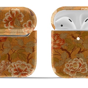 May include: A floral patterned case for AirPods with a built-in keychain. The case is open to reveal the white AirPods inside.