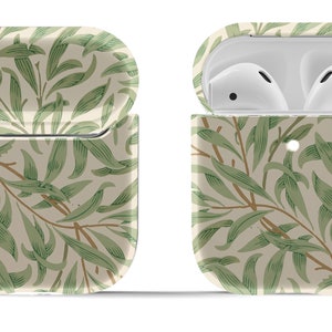 May include: A green and cream floral patterned Airpods case with a silver keychain.